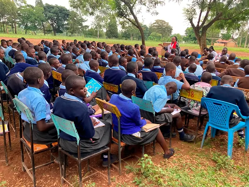 A PadMad educator conducting a Menstrual Health Education workshop for a diverse group of school girls and boys in Kenya.