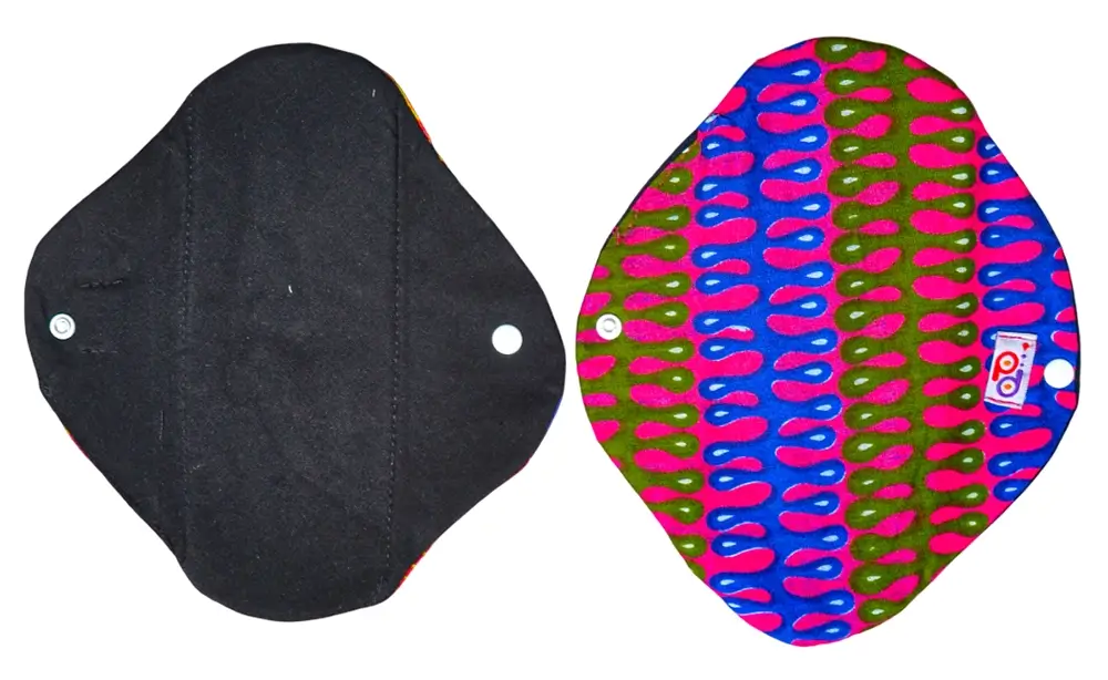 Front and reverse view of the PadMad Daytime reusable pad, showcasing its colorful Kitenge pattern on one side and a clean, absorbent surface on the other.