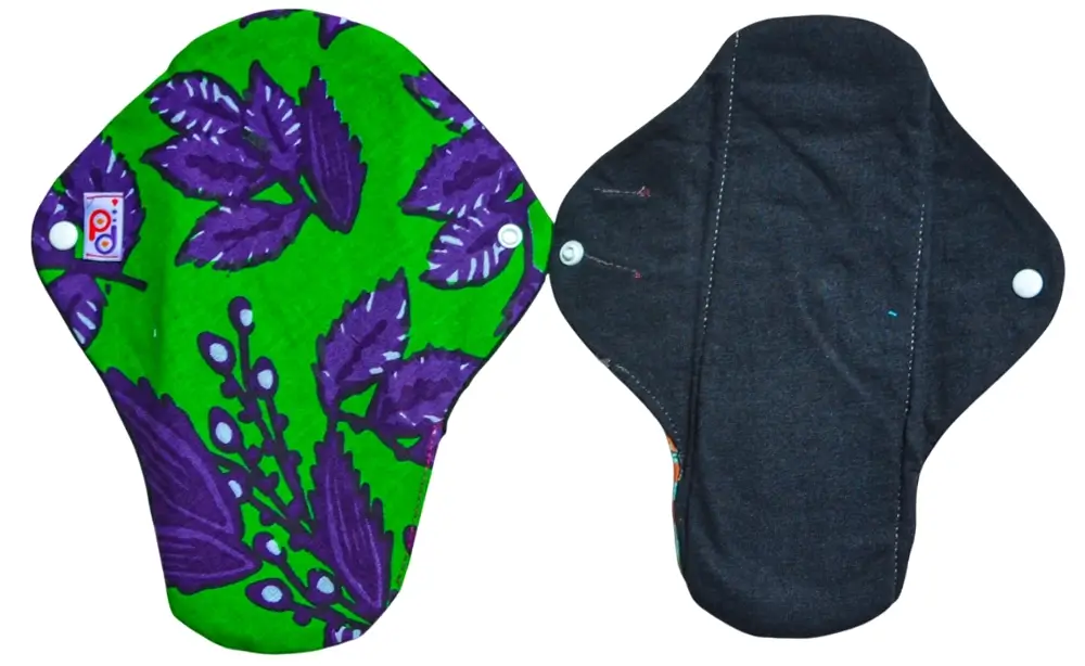 Comparison view of the front and reverse sides of a PadMad Nighttime pad, featuring a larger, highly absorbent design with a colorful floral Kitenge pattern.